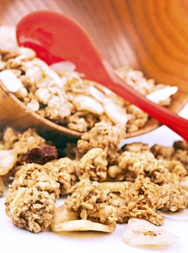 spoon and bowl with muesli dried fruit and cereals