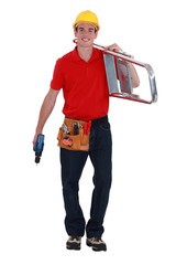 Young handyman with a ladder and drill