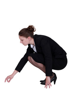 Businesswoman picking a speck up off the floor