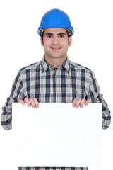 craftsman holding a blank poster