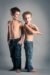 Two young brothers studio portrait.