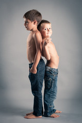 Two young brothers studio portrait.