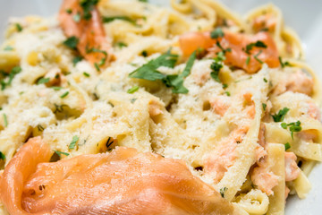 plate of pasta and smoked salmon with tomato