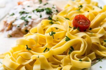 plate of pasta and smoked salmon with tomato