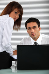 Obraz premium Two eager business people working overtime