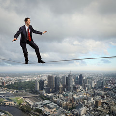 Balancing businessman and cityscape