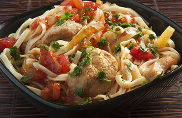 Italian pasta with tomatoes and meat close up