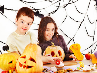 Halloween party with children holding trick or treat.