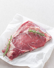 raw steak on white paper