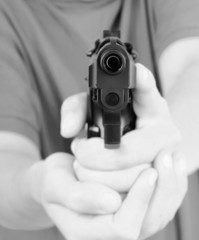 hand with gun, short focus on the gun