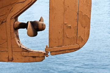 Abstract fragment of old safe-boat propeller and rudder © evannovostro