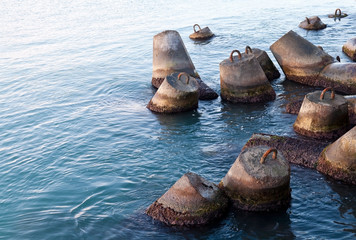 Fototapeta premium Old concrete breakwater embankment fragments