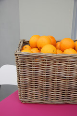 Wicker basket with oranges