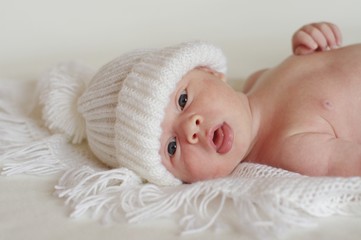 The newborn in a white knitted cap