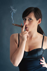 Fototapeta premium Woman smoking cigar. Studio fashion photo.