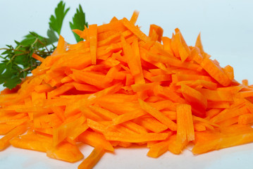 Carrot sticks in a pile, on white background