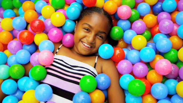 Cute African American Girl Enjoying Ball Pool