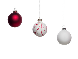 One red and two white Christmas baubles - isolated