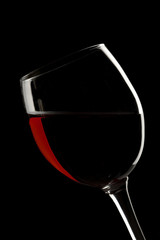 Elegant red wine glass in a black background