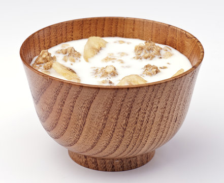 wooden bowl of cereal and milk