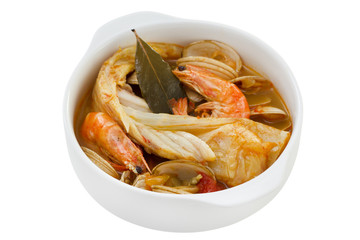 fish with seafood and vegetables in white bowl