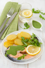 boiled salmon with sauce and potato on the plate