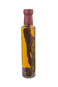 glass bottle with spicy herbs and olive oil, isolated