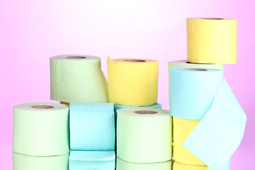 bright rolls of toilet paper on pink background