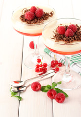 fruit jelly with berries in glasses on wooden table