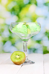 delicious ice cream on wooden table on bright background