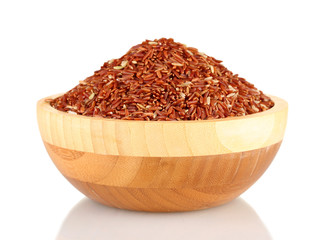 red rice in a  brown wooden plat, isolated on white