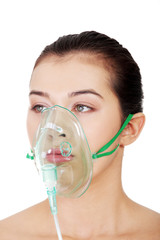 Diseased female patient wearing a oxygen mask