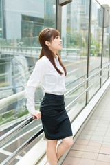 Beautiful business woman walking outside her office