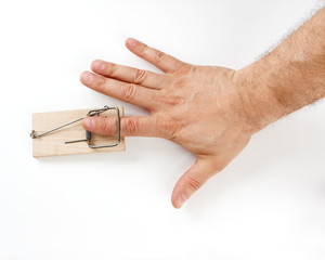 Male finger caught by mouse trap on white background - obrazy, fototapety, plakaty