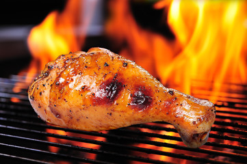 Grilled chicken leg on the grill.