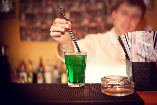 Barman making cocktail at the night club