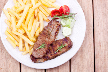grilled steak with french fries and salad