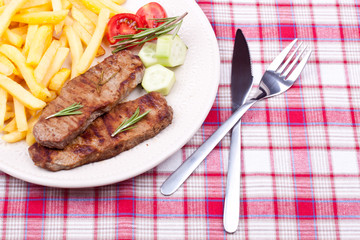 grilled steak with french fries and salad