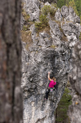 Young woman climbing the rock