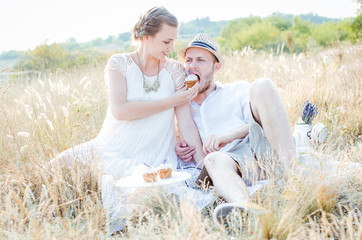 Young couple eating muffin outdoor