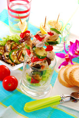 chicken and vegetable skewers served in glass