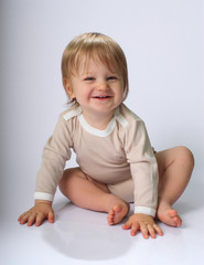 Fototapeta premium Little child sitting on floor
