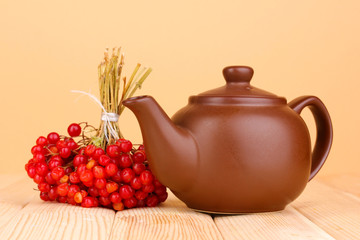 Obraz na płótnie Canvas tea with red viburnum on table on beige background