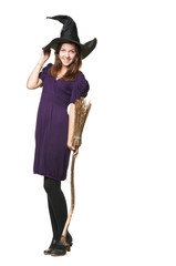 The  young pretty witch with a broom and hat