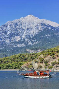 Yacht in a bay on mountains background