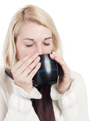 Young blonde woman drinks a cup of tea - isolated