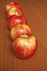Tasty red apples on table