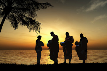 Silhouettes of monks on the beach, Thailand