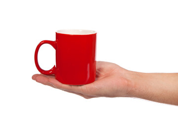Male hand is holding a red cup
