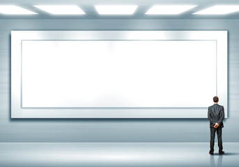 Obraz premium Business person standing near a blank billboard